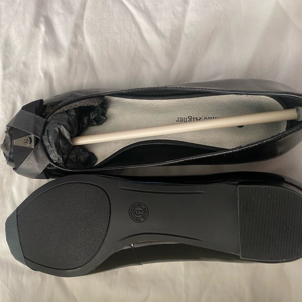 Very classic open toe black patent leather flats.